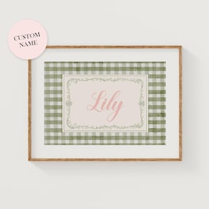 May include: Framed wall art featuring a green and white gingham pattern. The center has a light pink rectangle with the name "Lily" in cursive. A pink circle with the text "CUSTOM NAME" is in the upper left corner.