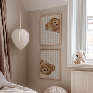 May include: Two framed prints with teddy bear illustrations on a beige and white checked background. A plush teddy bear sits on a windowsill. A white paper lantern hangs from the ceiling.