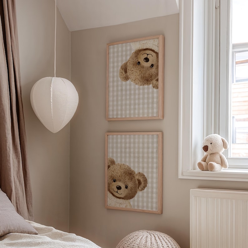 May include: Two framed prints with teddy bear illustrations on a beige and white checked background. A plush teddy bear sits on a windowsill. A white paper lantern hangs from the ceiling.