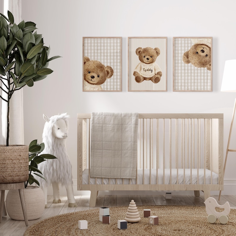 May include: A nursery scene featuring three framed prints of brown teddy bears. The prints are set against a beige and white checkered and striped backdrop. A wooden cot, a white llama, and a woven rug are also visible.