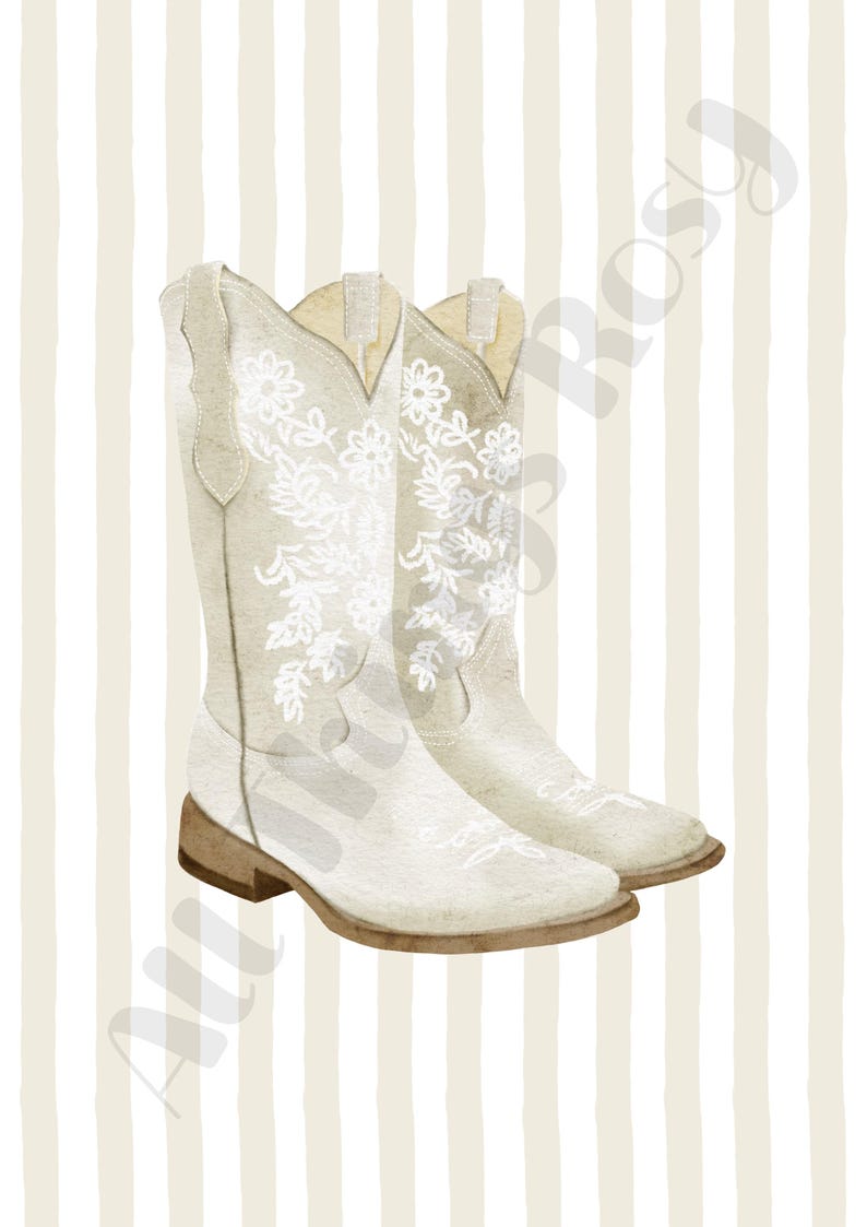 May include: A pair of off-white cowboy boots with floral embroidery. The boots have a classic design with a pointed toe and a stacked heel. The background features vertical beige and white stripes.