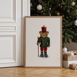 May include: A framed print depicting a teddy bear in a toy soldier's uniform. The bear is dressed in a green jacket, red trousers, a black hat, and boots. It holds a cane and wears a red and green scarf. A Christmas tree is in the background.