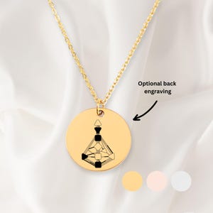 May include: Gold necklace with a round pendant featuring a geometric design. The pendant can be engraved on the back. The necklace is available in gold, rose gold, and silver.