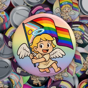 May include: A collection of colorful button pins featuring a cartoon angel holding a rainbow pride flag. The angel has a halo and is wearing a white robe. The background is a gradient of pink, purple, and blue.