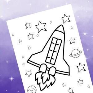 May include: A black and white line drawing of a rocket ship taking off into space. The rocket has a large window and a long tail of flames. There are stars and a planet in the background.
