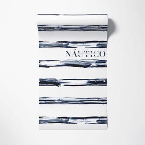 May include: A roll of white wallpaper with blue watercolor stripes and the text "N&Aacute;UTICO LUXURY WALLPAPER".