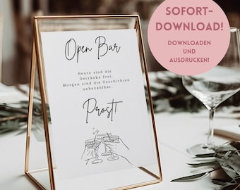 Könnte beinhalten: Ein druckbares Schild mit dem Text "Open Bar" in schwarzer Kursivschrift. Das Schild enthält auch den Text "Heute sind die Getränke frei. Morgen sind die Geschichten unbezahlbar. Prost!" in schwarzer Schrift. Das Schild ist in einem goldenen Metallrahmen gerahmt und steht auf einem Tisch. Das Schild ist ein druckbarer Download.