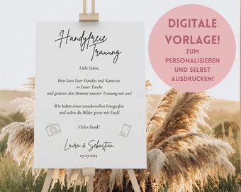 Puede incluir: Un cartel blanco con el texto "Handyfreie Trauung" en escritura cursiva negra. El cartel también incluye el texto "Liebe Gäste, bitte lasst Eure Handys und Kameras in Eurer Tasche und geniesst den Moment unserer Trauung mit uns! Wir haben einen wundervollen Fotografen und teilen die Bilder gerne mit Euch! Vielen Dank! Laura & Sebastian 07.07.2023". El cartel está en un caballete de madera y está rodeado de hierba de pampa seca. El texto "DIGITALE VORLAGE! ZUM PERSONALISIEREN UND SELBST AUSDRUCKEN!" está en un círculo rosa en el lado derecho de la imagen.