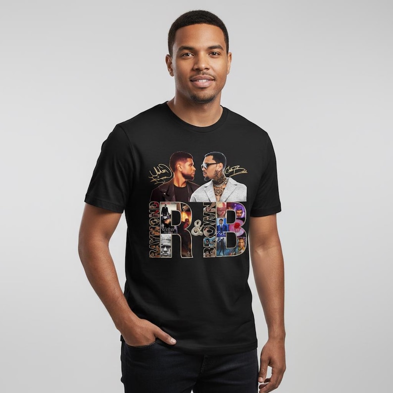 May include: Black t-shirt featuring a graphic design with the text "R&B" in a collage of images and the faces of two men. The shirt is a crew neck style.