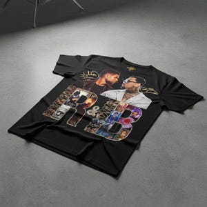 May include: Black t-shirt featuring a graphic design with the text "Raymond & Brown" in a collage style. The design includes images of two men and their signatures. The shirt is made of a soft material.
