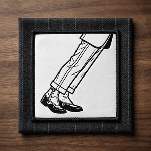 May include: Black and white illustration of a person's legs and feet in a classic pose, wearing dress pants and shoes. The image is on a square, dark gray fabric coaster with a pinstripe pattern.