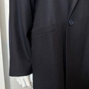 May include: A black long-sleeved blazer with a single button closure and a pocket on the left side.