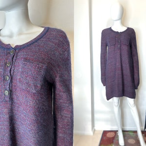 May include: A long-sleeved, purple and blue sweater dress with a button-up front and two pockets. The dress is made of a soft, fuzzy material.
