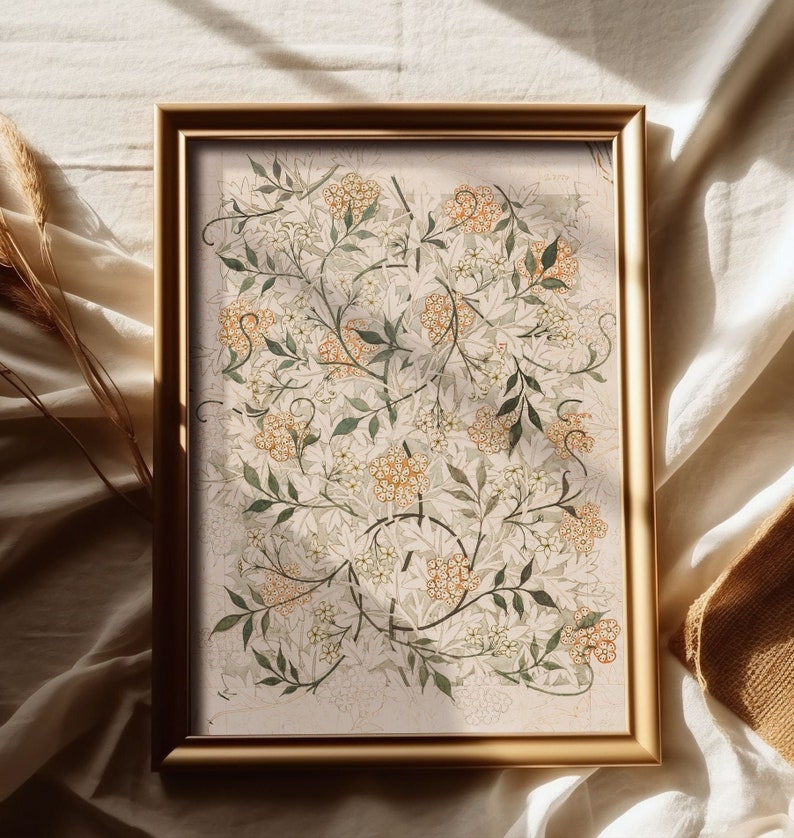 May include: A framed print of a botanical illustration featuring a detailed depiction of a flowering plant with white and orange blossoms and green leaves. The print is set against a light beige background.