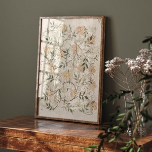 May include: A framed botanical print featuring a delicate floral design with white and yellow flowers and green leaves on a white background.