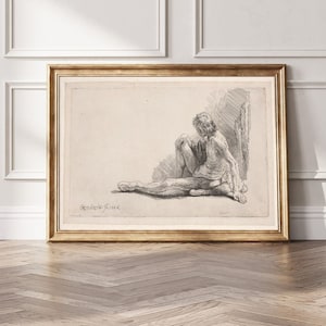 K&ouml;nnte beinhalten: Eine Schwarzwei&szlig;-Radierung einer sitzenden nackten Figur, die Figur ist vom Betrachter abgewandt und blickt nach unten. Die Radierung ist in einem goldenen Rahmen gerahmt.