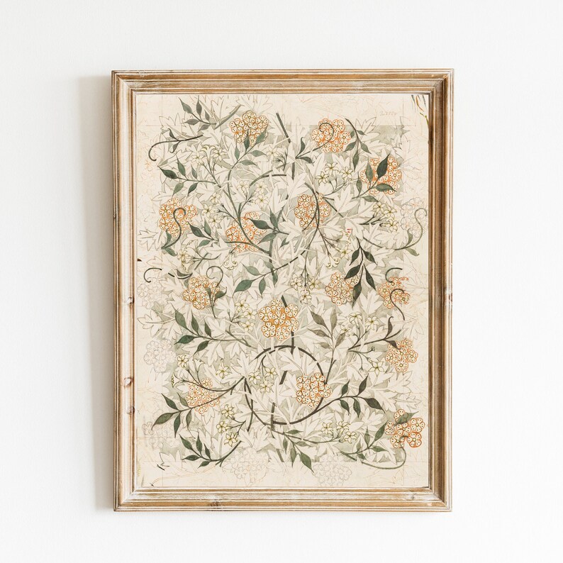 May include: A framed print of a botanical illustration featuring a delicate floral design with intricate details. The artwork features a light beige background with a pattern of green leaves and small white flowers, accented with clusters of orange-yellow flowers.