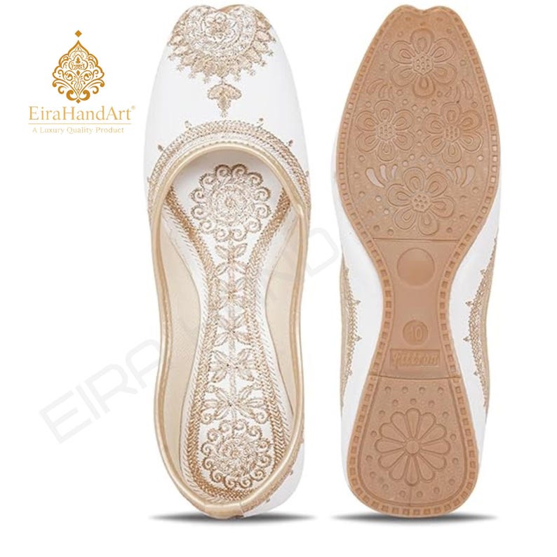 May include: A pair of white slip-on shoes featuring intricate gold embroidery on the upper surface and a tan rubber sole with a floral tread pattern. The interior insole is also decorated with matching gold embroidery. The size 10 is visible.