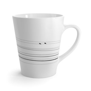 May include: White ceramic latte mug with a black and white design of birds on a wire. The design is repeated across the mug.