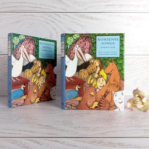 May include: Two copies of "Nonsense Songs" by Edward Lear, illustrated by Jonathan Allen. The book covers display a colourful illustration of a pelican, animals, and musical instruments. The spines are blue.