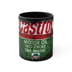 May include: Black ceramic mug with a vintage Castrol motor oil can design. The can is green and red with the text "MOTOR OIL TWO-STROKE SELF-MIXING" and a Castrol logo.