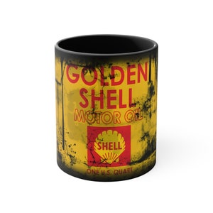 May include: Black ceramic mug with a vintage-style design featuring a yellow and red can of Golden Shell Motor Oil. The can has a Shell logo and the text "One U.S. Quart".