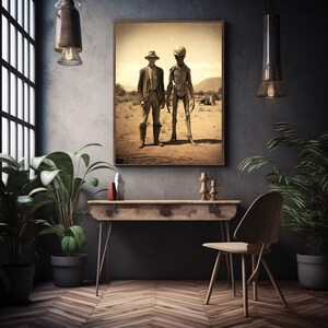May include: A sepia-toned photograph of a man in a cowboy hat standing next to a tall, skeletal alien. The image is framed and hanging on a dark wall.