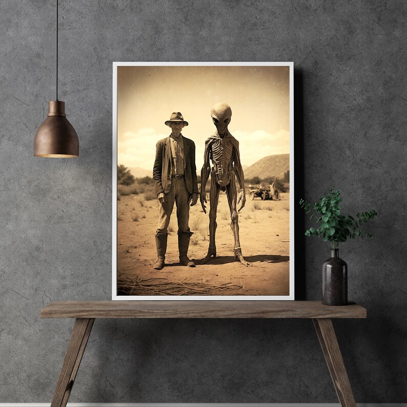 May include: A sepia-toned photograph of a man in a cowboy hat standing next to a tall, grey alien. The man is wearing a long-sleeved shirt and pants, and the alien has a skeletal appearance. They are both standing in a desert landscape.