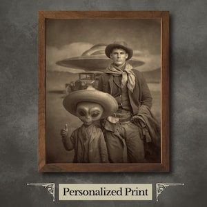 May include: Sepia-toned framed print featuring a cowboy and an alien, both wearing hats, standing in front of a vintage car and a UFO. The alien gives a thumbs-up. The print has the text "Personalized Print" at the bottom.
