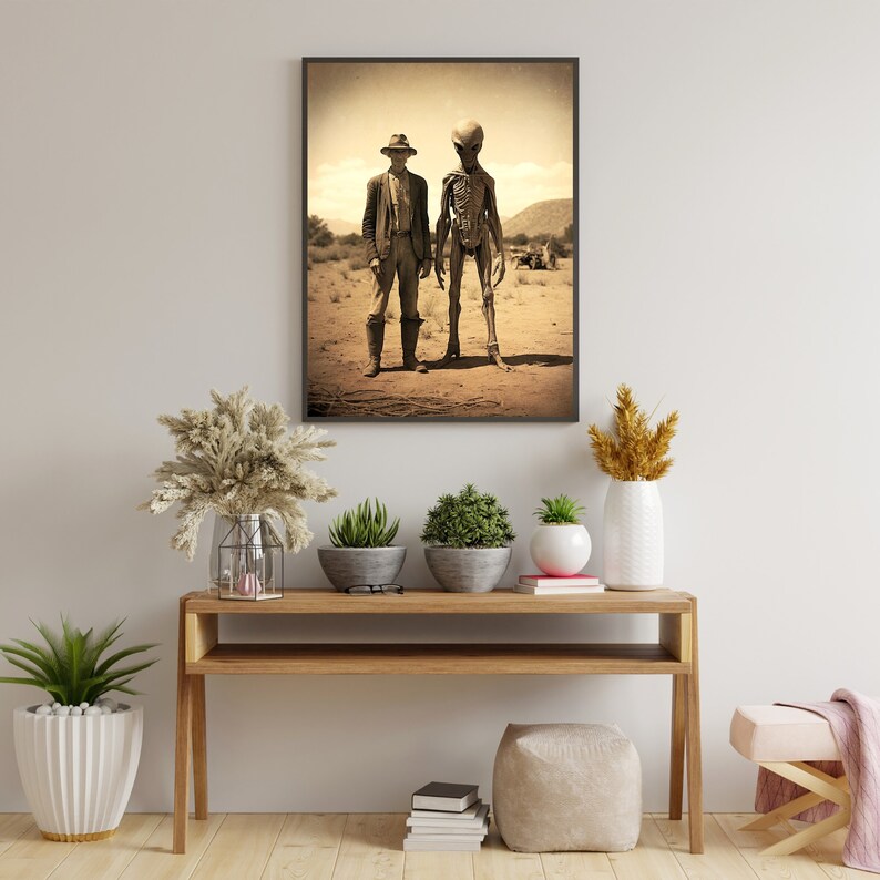 May include: A sepia-toned photograph of a man in a hat standing next to a tall, skeletal alien figure in a desert landscape.