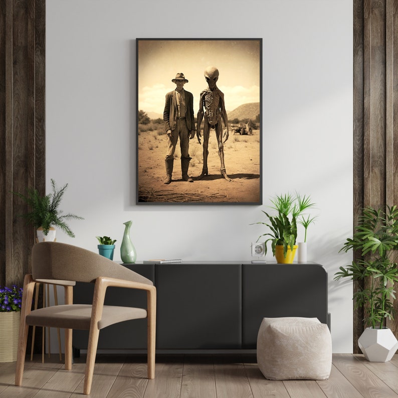 May include: A sepia-toned photograph of a man in a cowboy hat standing next to an alien in a desert landscape.
