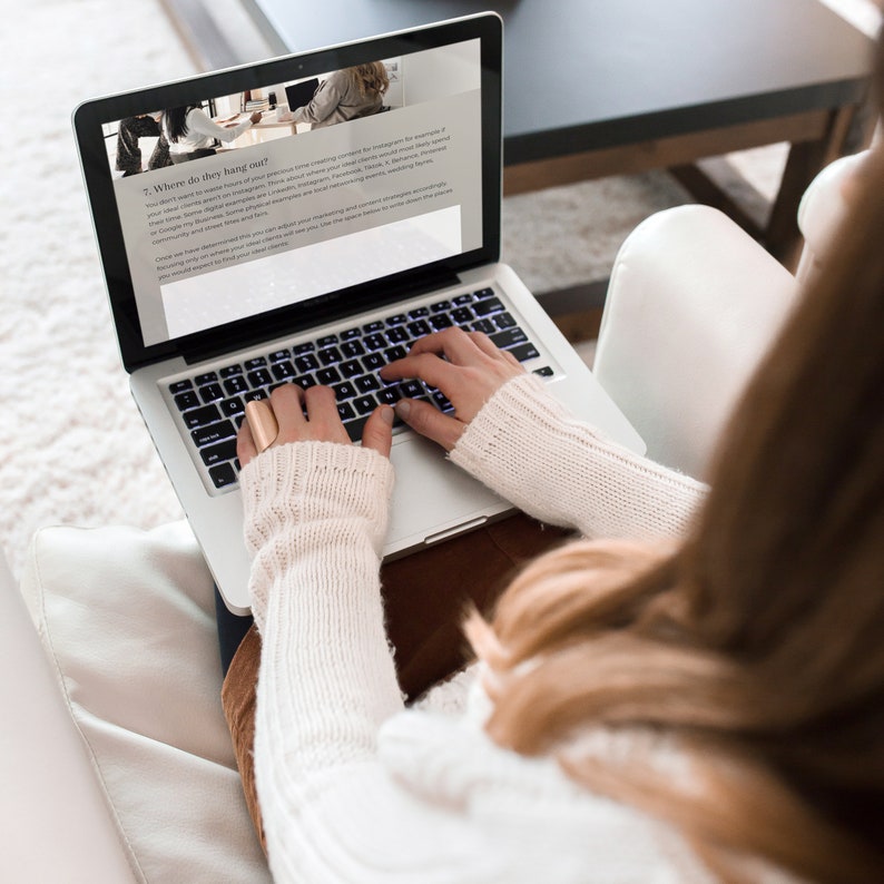 A woman working through the workbook on her laptop