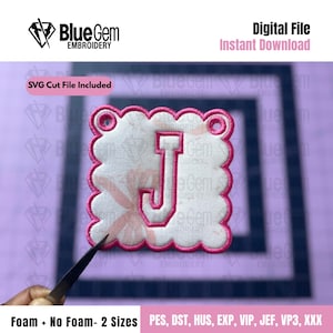 May include: An embroidered patch featuring the letter "J" in a pink and white design. The patch has a scalloped edge and includes the text "Blue Gem Embroidery", "SVG Cut File Included", and "Digital File Instant Download".