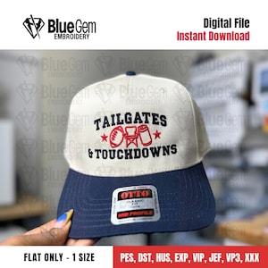 May include: A two-tone baseball cap with a white crown and a navy blue brim. The cap features the embroidered text "TAILGATES & TOUCHDOWNS" with football and drink graphics. The hat has a "OTTO" brand tag.