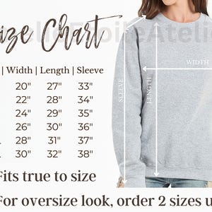 May include: A size chart for a gray sweatshirt, with measurements in inches for width, length, and sleeve length. The chart includes sizes S to 3XL, with a note indicating the fit is true to size and to order two sizes up for an oversized look.