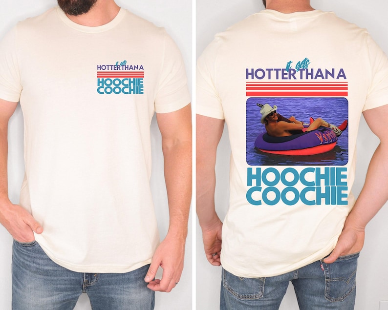 May include: Cream-colored t-shirt with the text "HOTTERTHANA HOOCHIE COOCHIE" in blue and red. The back of the shirt features a graphic of a person in a tube on the water, with the same text.