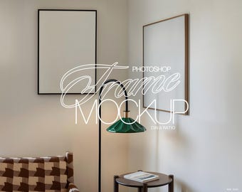 May include: Two empty picture frames, one black and one brown, are hanging on a white wall. A green lamp with a black stand is in the corner of the room. A brown and white patterned armchair is in the foreground. The text "PHOTOSHOP Frame MOCKUP DIN A RATIO" is visible in the image.