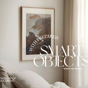 May include: A mockup of a framed seascape painting with the text "Prepared with Smart Objects" and "artwork not included" below the frame. The painting is hanging on a white wall above a white bed with a white pillow.