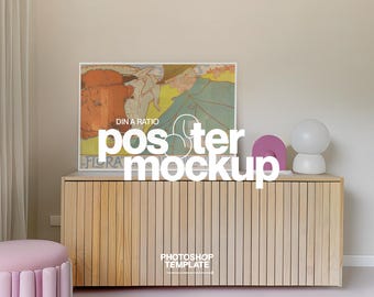 May include: A wooden cabinet with vertical slats holds a framed poster with a vintage illustration. A pink arch and a white globe lamp sit on top. The word "poster mockup" is displayed in white, with "Photoshop Template" below.