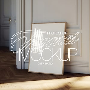 May include: A wooden frame mockup with a white background and the text "PHOTOSHOP Frames MOCKUP DIN A RATIO" on the frame. The frame is leaning against a white wall in a room with a wooden floor.