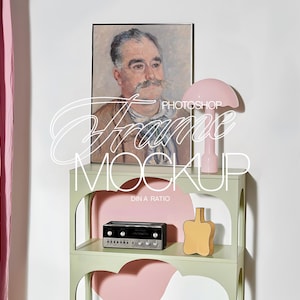 May include: A light green shelving unit with three shelves. The top shelf features a framed painting of a man with a moustache, a pink lamp, and a small yellow vase. The middle shelf has a black stereo system. The bottom shelf is empty.