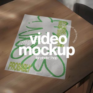 May include: A white paper with green abstract designs and text that reads "video mockup for photoShop" and "Probably". The paper is on a wooden table with shadows.