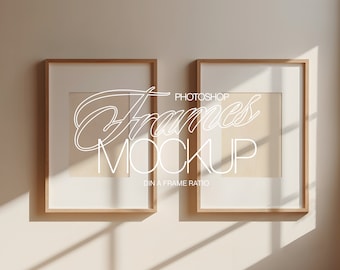 May include: Two wooden picture frames with white mats and a white background. The frames are hanging on a light beige wall. The text "Photoshop Frames Mockup DIN A Frame Ratio" is written in white on the wall.
