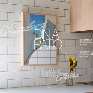 May include: A framed print of a blue and white landscape with the text "Standard Dina Ratio" and "Flowers Can Be Hidden" below the image. The print is hanging on a white tiled wall in a kitchen.