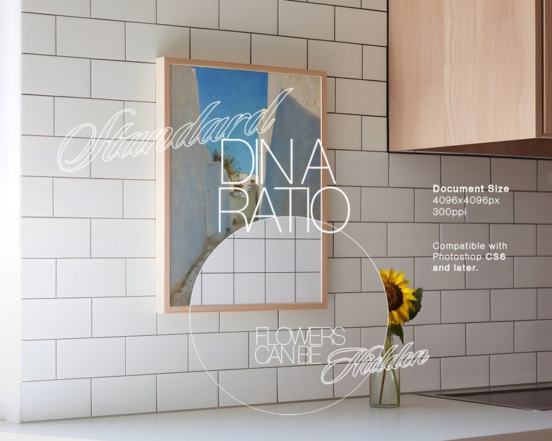 May include: A framed print of a blue and white landscape with the text "Standard Dina Ratio" and "Flowers Can Be Hidden" below the image. The print is hanging on a white tiled wall in a kitchen.