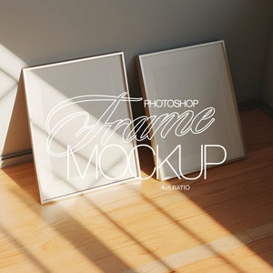 May include: Two white picture frames with a silver border, leaning against a wall. The frames are empty and ready for a photo or artwork. The text "Photoshop Frame Mockup 4x5 Ratio" is written on the floor.