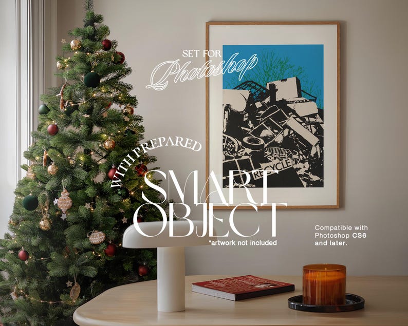 May include: A framed print of a black and white illustration of a pile of scrap metal with the word "RECYCLE" visible. The print is hanging on a white wall next to a Christmas tree decorated with red and gold ornaments. A white lamp and a candle are on a wooden table in the foreground.