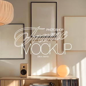 May include: A room setting with four framed art prints, two with black frames and two with natural wood frames. The wall is a light colour. The text "Photoshop Frame Mockup" is overlaid on the image.