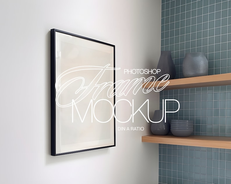 May include: A black framed picture mockup hanging on a white wall, with a shelf above it containing a gray vase and a stack of gray bowls. The wall behind the shelf is tiled in a light blue color.