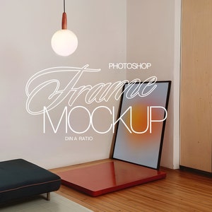 May include: A black frame mockup with a gradient background, sitting on a red platform. The frame is in a corner of a room with a white wall and a wooden door. A white pendant light hangs from the ceiling above the frame.